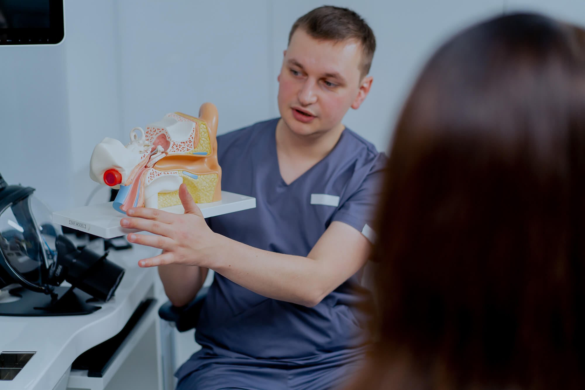 An ENT doctor consults a patient in the clinic.