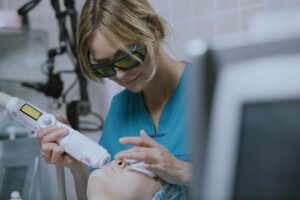 Woman having a laser skin treatment in a skincare clinic.