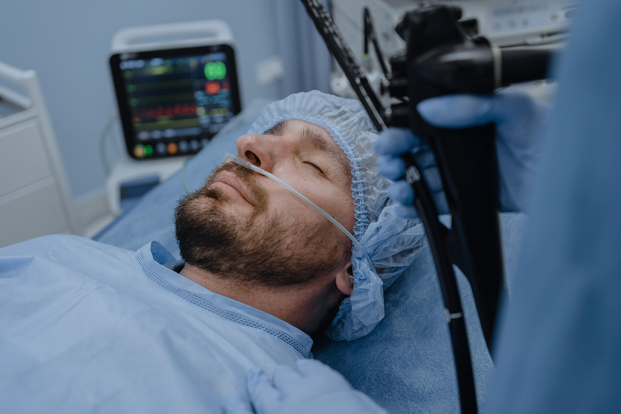 Male patient lying on the operating table under anesthesia.