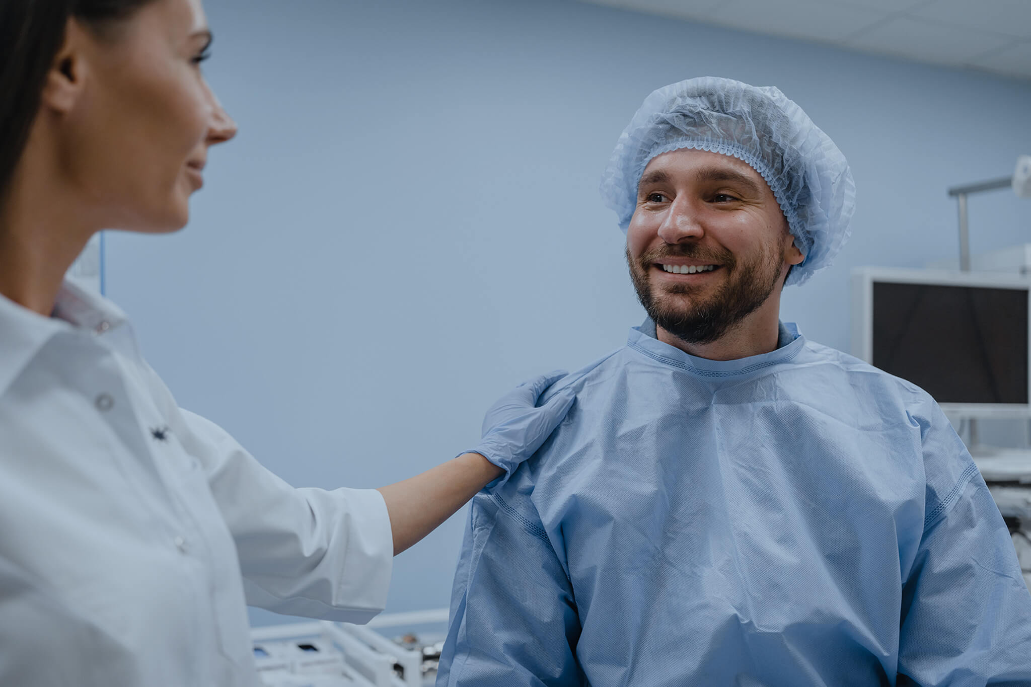 Gastroenterologist talks to a male patient before gastroduodenoscopy procedure.