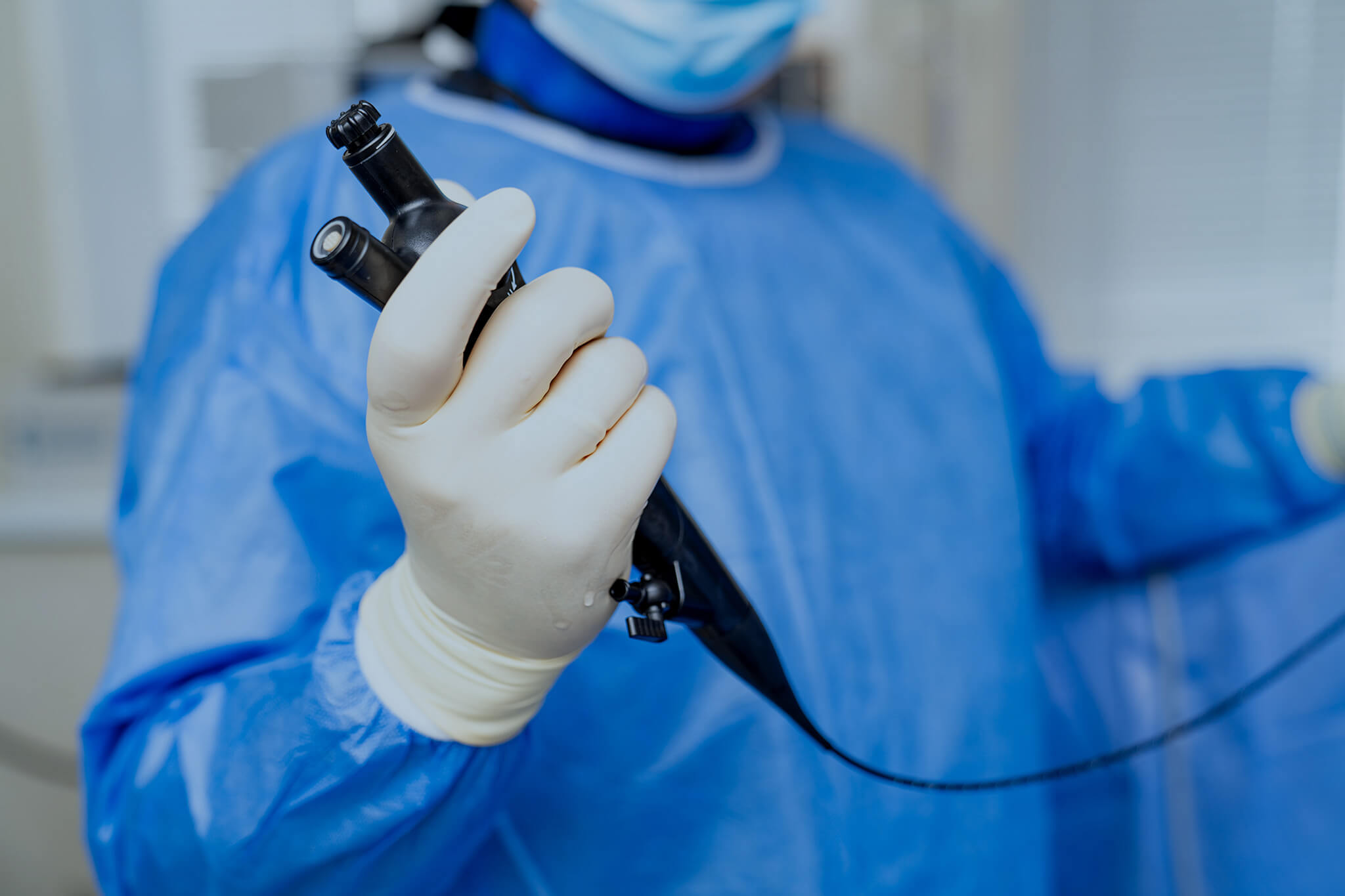 Doctor holding endoscope.