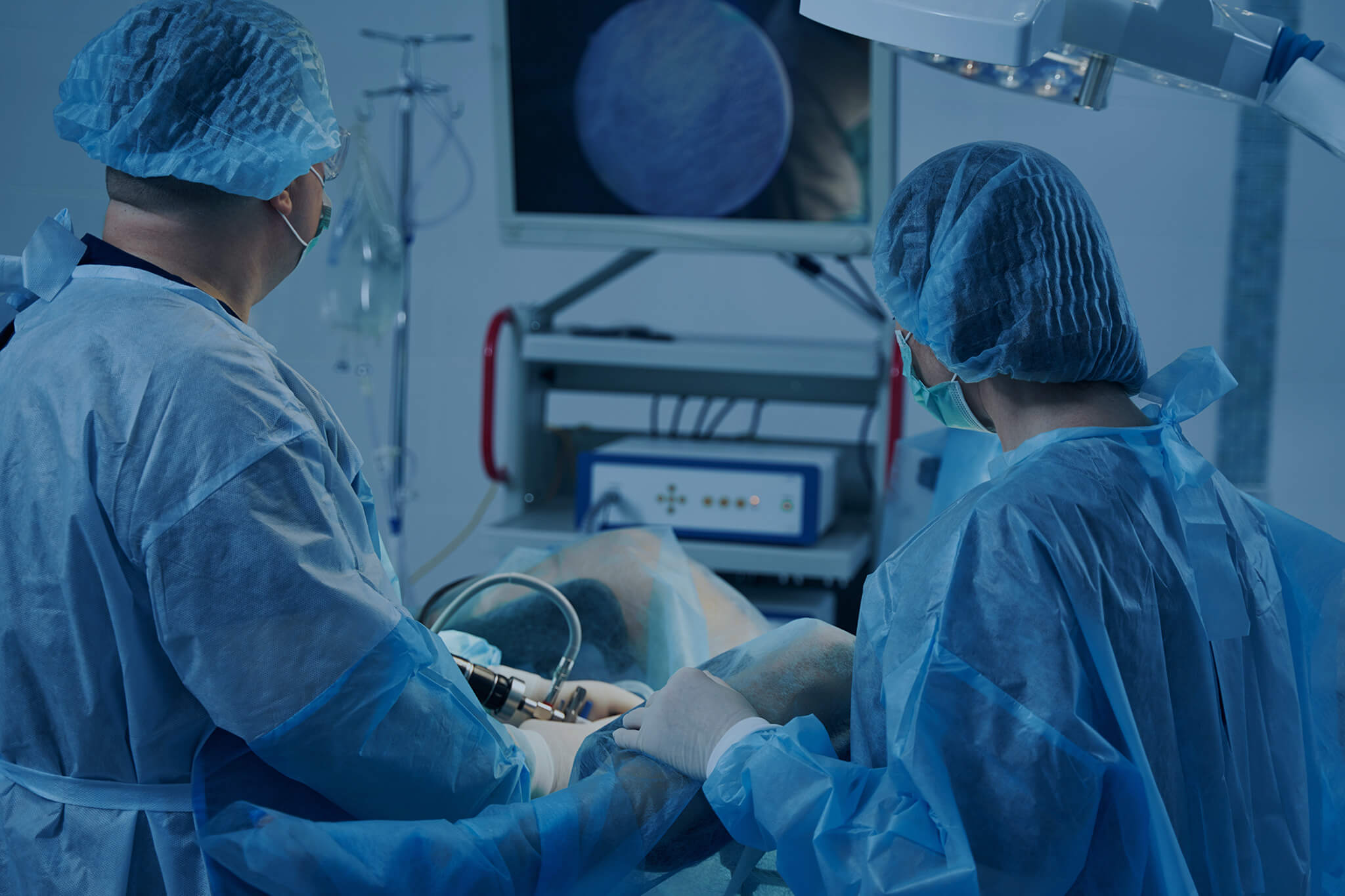 Doctors performing hysteroscopy procedure in the operating room.