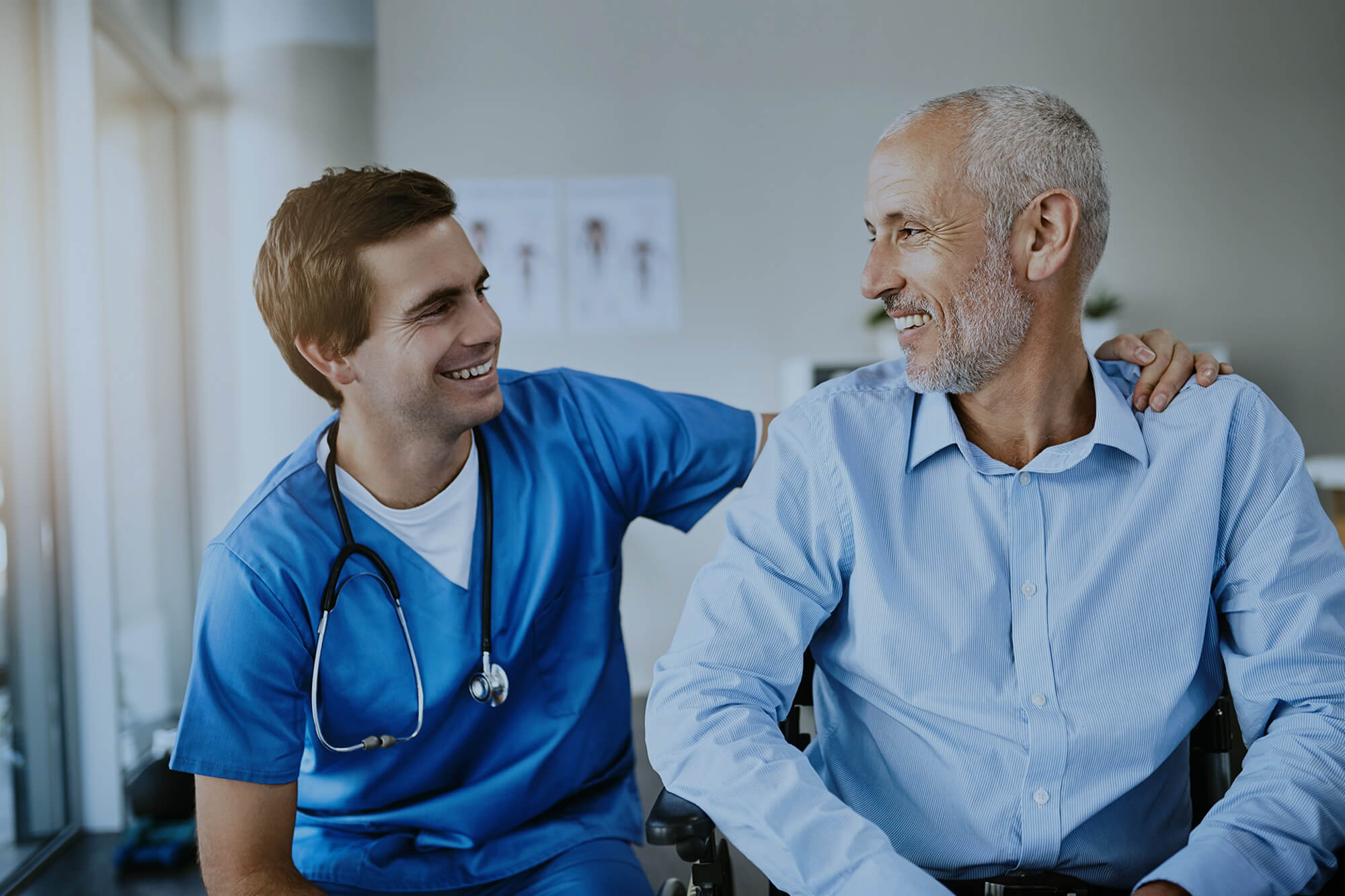 Nurse showing support to a man in the hospital.