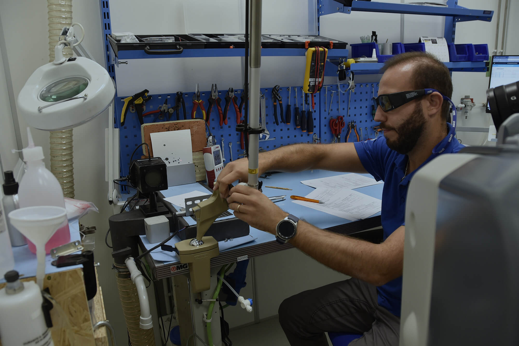 Technician performing a CO₂ laser machine test.